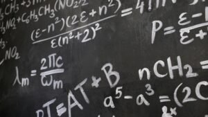 Close-up view of a blackboard filled with complex mathematical equations and formulas.