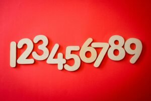 Creative display of numbers one to nine on a vibrant red background, ideal for educational materials.